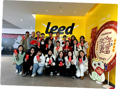 A team photo in front of the company logo.